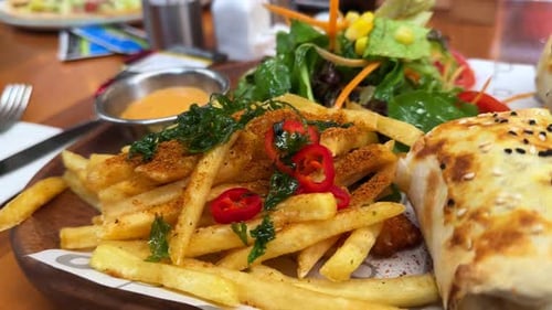 Close Up of Fries, Wrap, and Salad on Plate