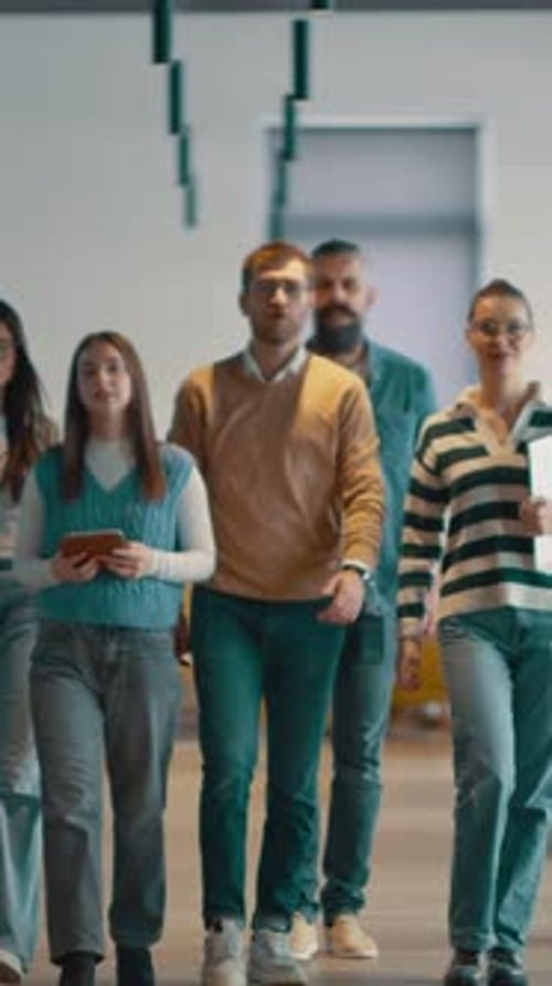 Business Team in a Modern Open Space Startup Office Walking Together Diverse Group of Businesspeople