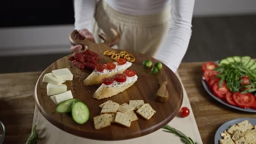 Woman Presents Delicious Food on Charcuterie Board