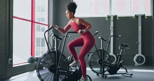 Exercise bike, cardio and girl cycling for sports fitness, athlete marathon training