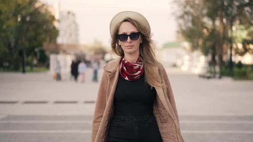 Woman in Hat and Sunglasses Walking in the City