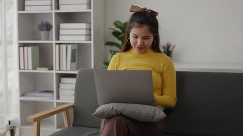 Woman Working on Laptop at Home