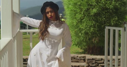 A girl in a classic bridal dress exploring the ruins of a historical fort.