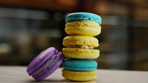 Close-up, bakery - a pyramid of delicious colored macaroons on a rotating surface