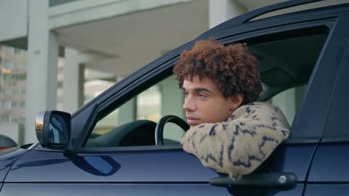 Driver Leaning Car Window Looking on Road at Urban Journey Closeup Latino Guy