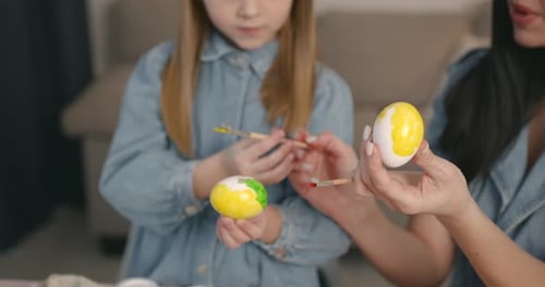 Mother with Daughter Painting Eggs for Easter