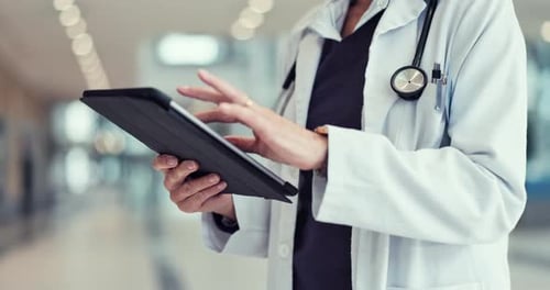 Doctor, hands and tablet in healthcare research, data or scrolling results at the hospital