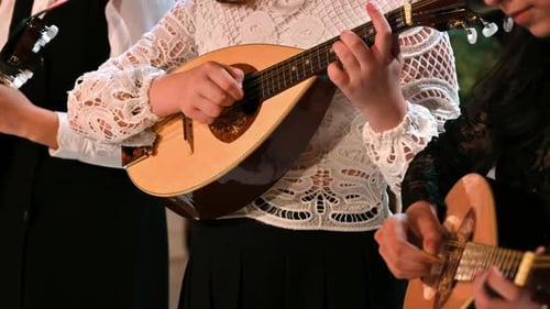 Close-up of three women playing the mandolin