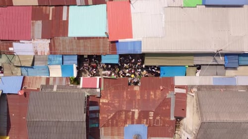 Aerial shot of Maeklong Railway Market with locals and trains, Thailand
