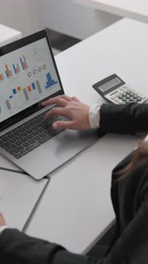 A Business Specialist Concentrates on Working in the Office Analyzing Documents and Compiling