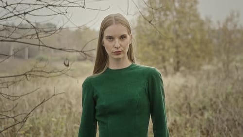 Model posing wearing green dress in autumn
