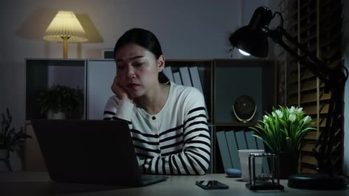 Tired Woman Working on Laptop at Night