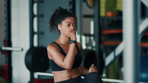 Woman Exercising in Gym Working on Fitness and Strength Training in Modern Facility