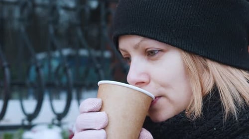 Winter Girl in Black Hat Drinking Green Matcha Latte From Paper Cup Close Up