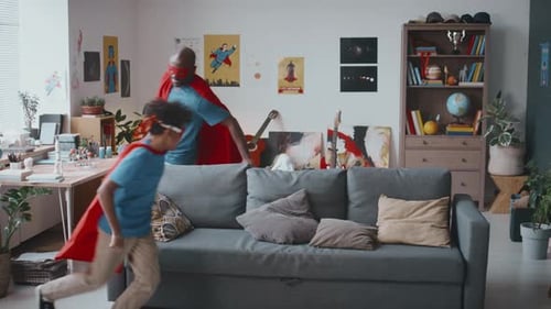 Father and Child Playing Superheroes at Home