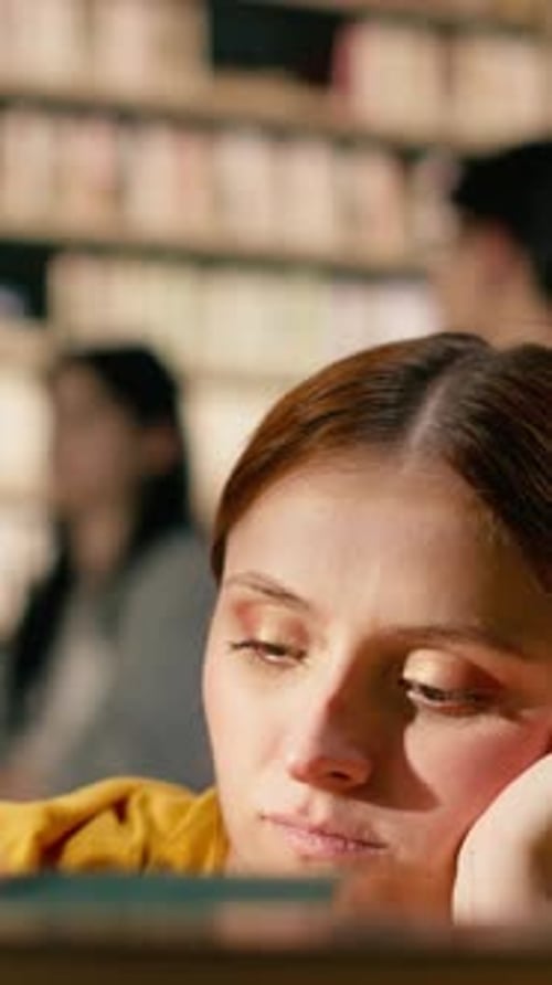 Vertical Video Overwhelmed Young Woman Holding Her Head Near Tall Stack of Books
