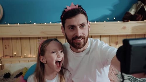 Father and Daughter Making Silly Faces for Camera