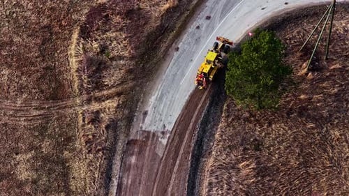 Straßengrader, der Feldweg formt und auf der Autobahn abbiegt, Luftaufnahme