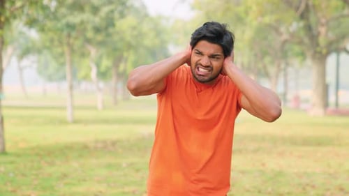 Young Indian Man Covering Ears From Loud Noise