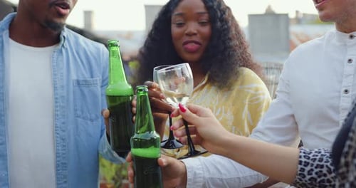 Friends Toasting with Drinks on City Rooftop