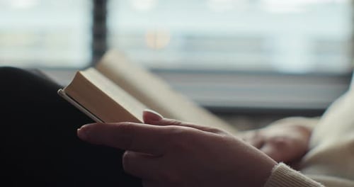 Young Woman Reading Book in Cozy Living Room Turning Page Learning Studying Education Read Books