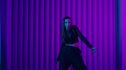 Young Female Dancer Dancing Contemporary Choreography In Studio With Neon Lights