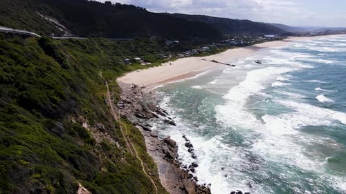 Picturesque Wilderness beach with rolling waves in Garden Route - aerial
