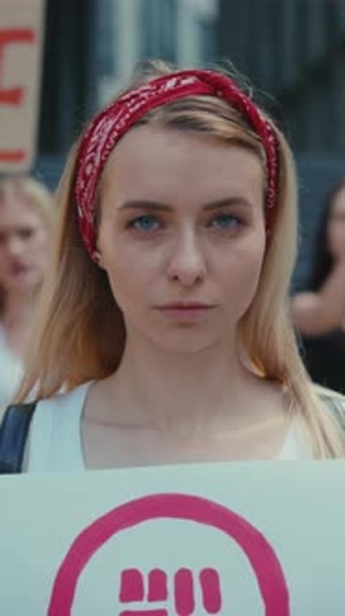 Blonde Woman Holding Sign at Protest March