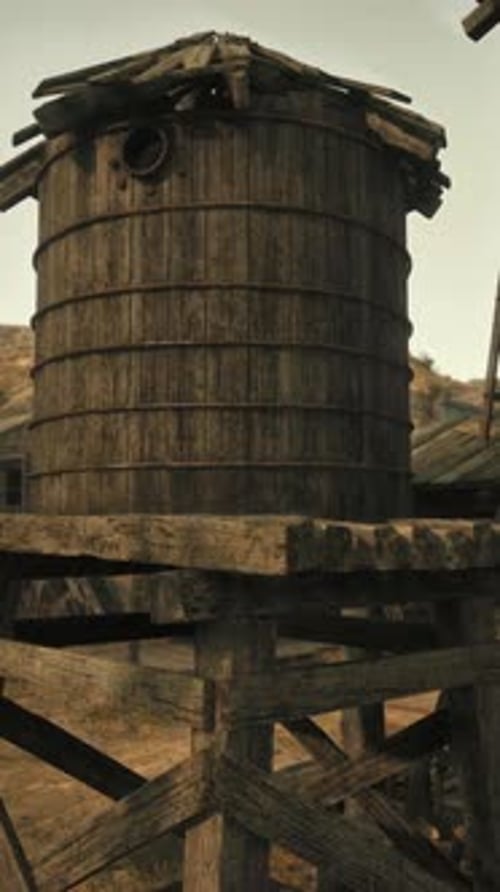 An Historic Wooden Building with a Charming Water Tower Beside It