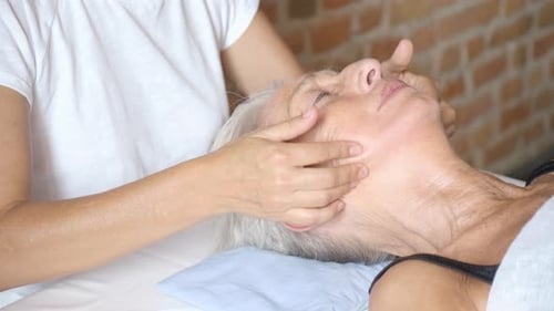 Senior Woman Enjoying Relaxing Facial Massage