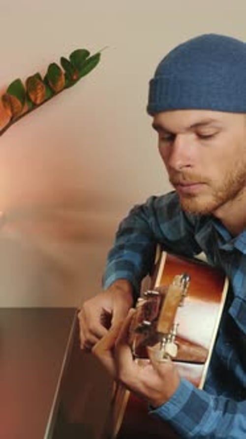 Guitarist artist performs guitar solo at sound recording studio. Vertical video