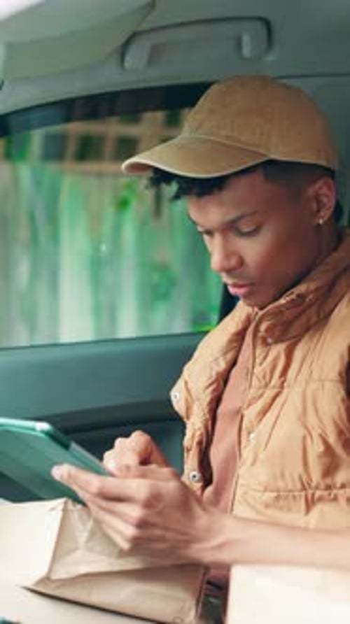 Young Man Using Tablet Inside Delivery Vehicle