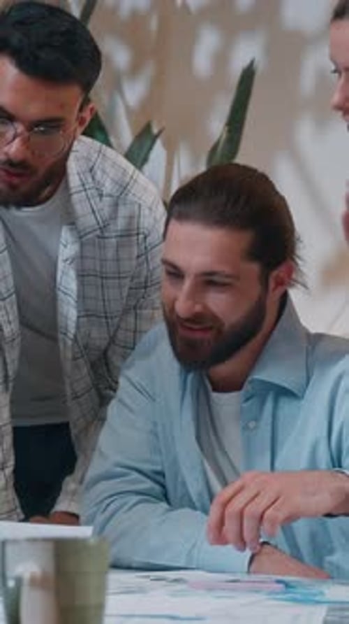 Casual Informal Business Team Five Creative Coworkers Discussing Papers Documents in Office Startup