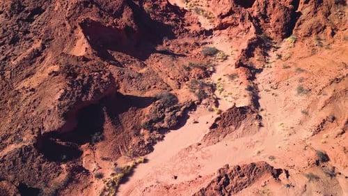 Aerial top view drone flying over scenic red rocky mountains