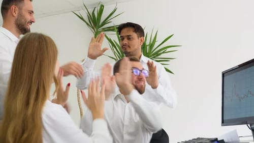 Team Celebrates Business Success in the Office
