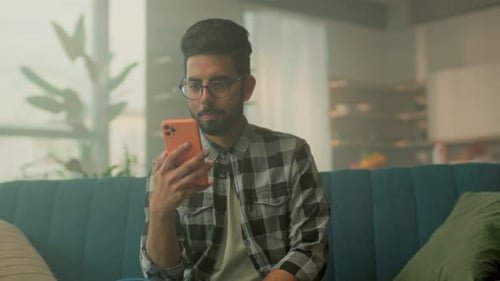 Individual Interacts with Application Prototype Person Examines User Interface While Relaxing in