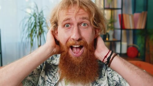 Surprised Man Reacts with Hands on Head