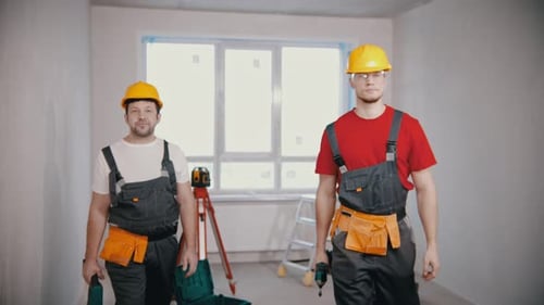 Apartment Repair Two Men Workers Standing in Draft Apartment