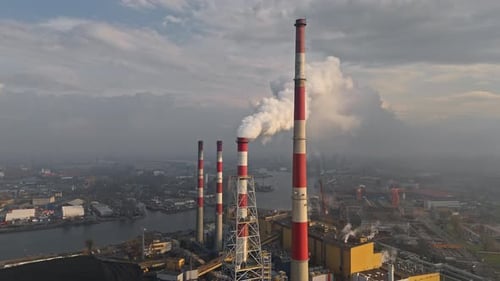 Air Pollution Concept Aerial Drone Video of a Factory Chimney in a City's Industrial Zone with Smoke