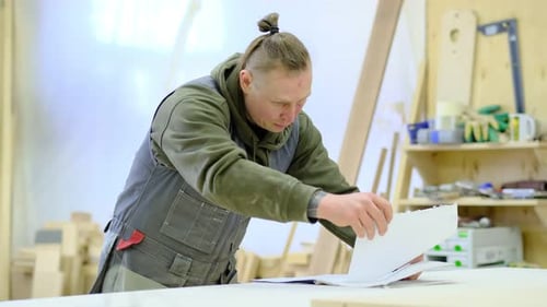Close Up Carpenter Examines His Documents Reads Work Plans Woodwork and Furniture Making Concept