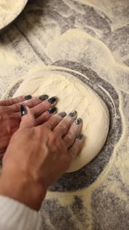 The chef makes delicious pizza in a professional kitchen.