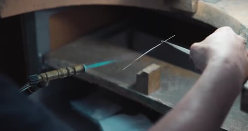 Jeweler Burns Silver Wire in Preparation for the Production of Jewelry or a Ring