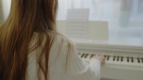 Girl Plays Piano at Home During Daytime
