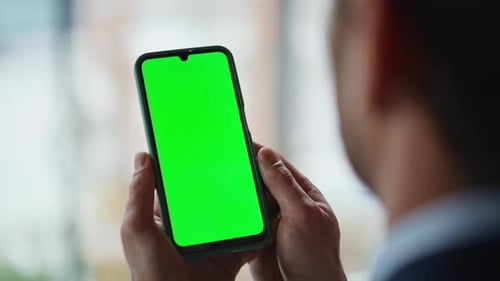 Businessman Hands Holding Greenscreen Cellphone at Office Workplace Closeup