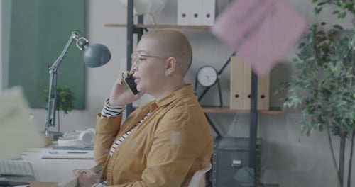 Woman Talking on the Phone in Office Workspace
