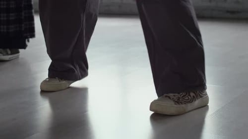 Legs of Unrecognizable Dancers Practicing Hip Hop Moves in Studio