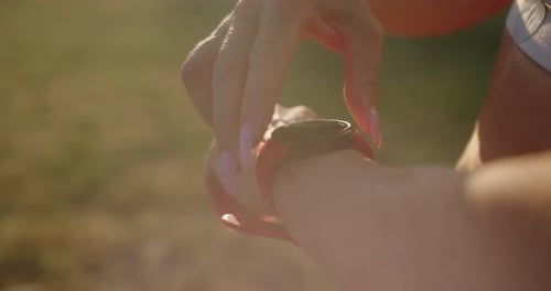 Woman Adjusts Smart Watch During Exercise