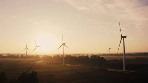 Aerial View Sunset Light Over Wind Turbines Farm Producing Renewable Energy