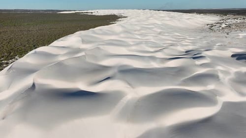 Aerial view of sand dunes near bushland, Australia.