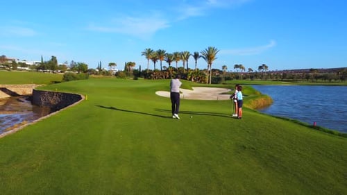 Family Golfing on Green Golf Course on Sunny Day